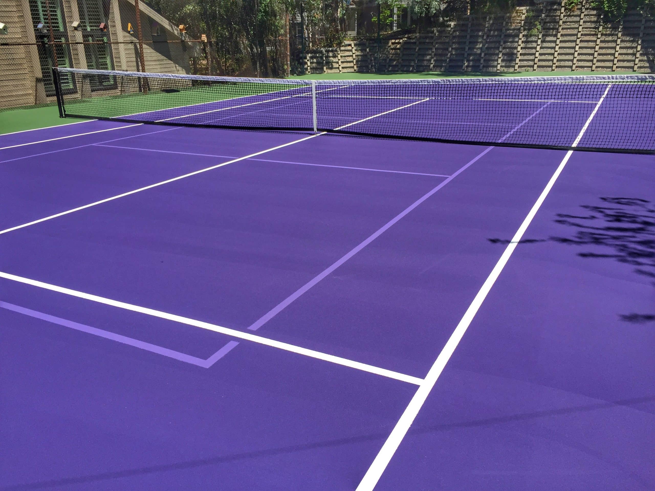 How Backyard Courts Can Boost Your Home’s Value Purple tennis court with white lines, part of a sports court gallery.