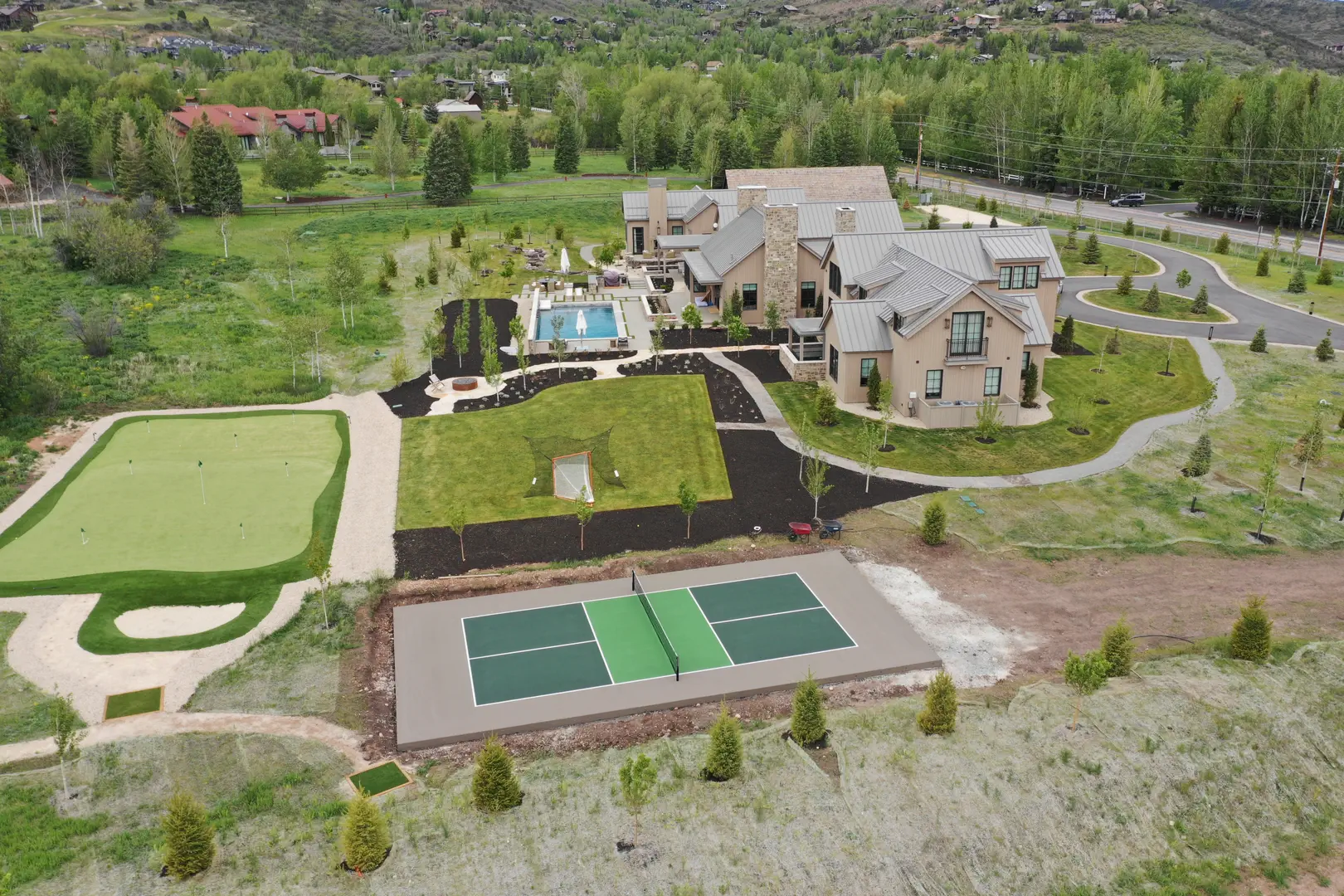 Luxury home with pickleball court, putting green, and pool in Park City, Utah.