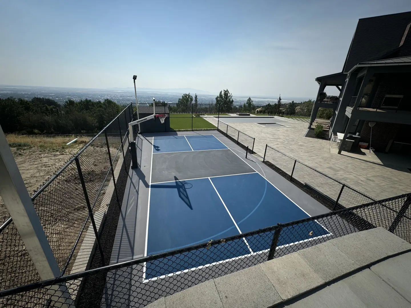 Scenic backyard basketball court with a view