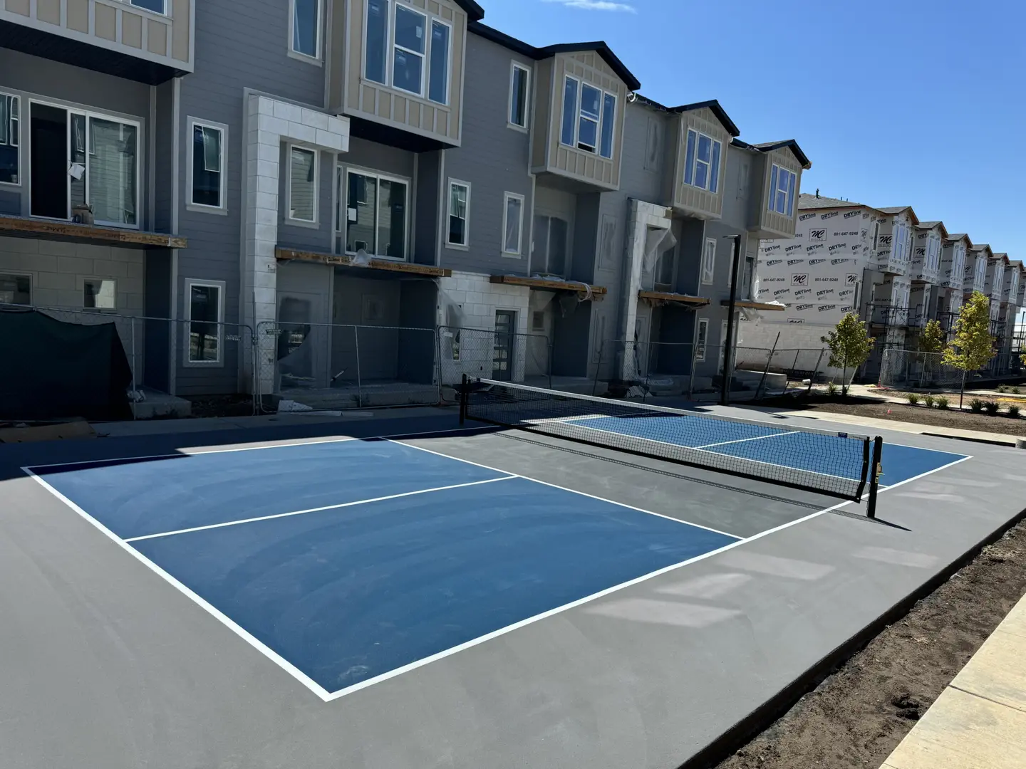 New pickleball courts in front of townhome construction.