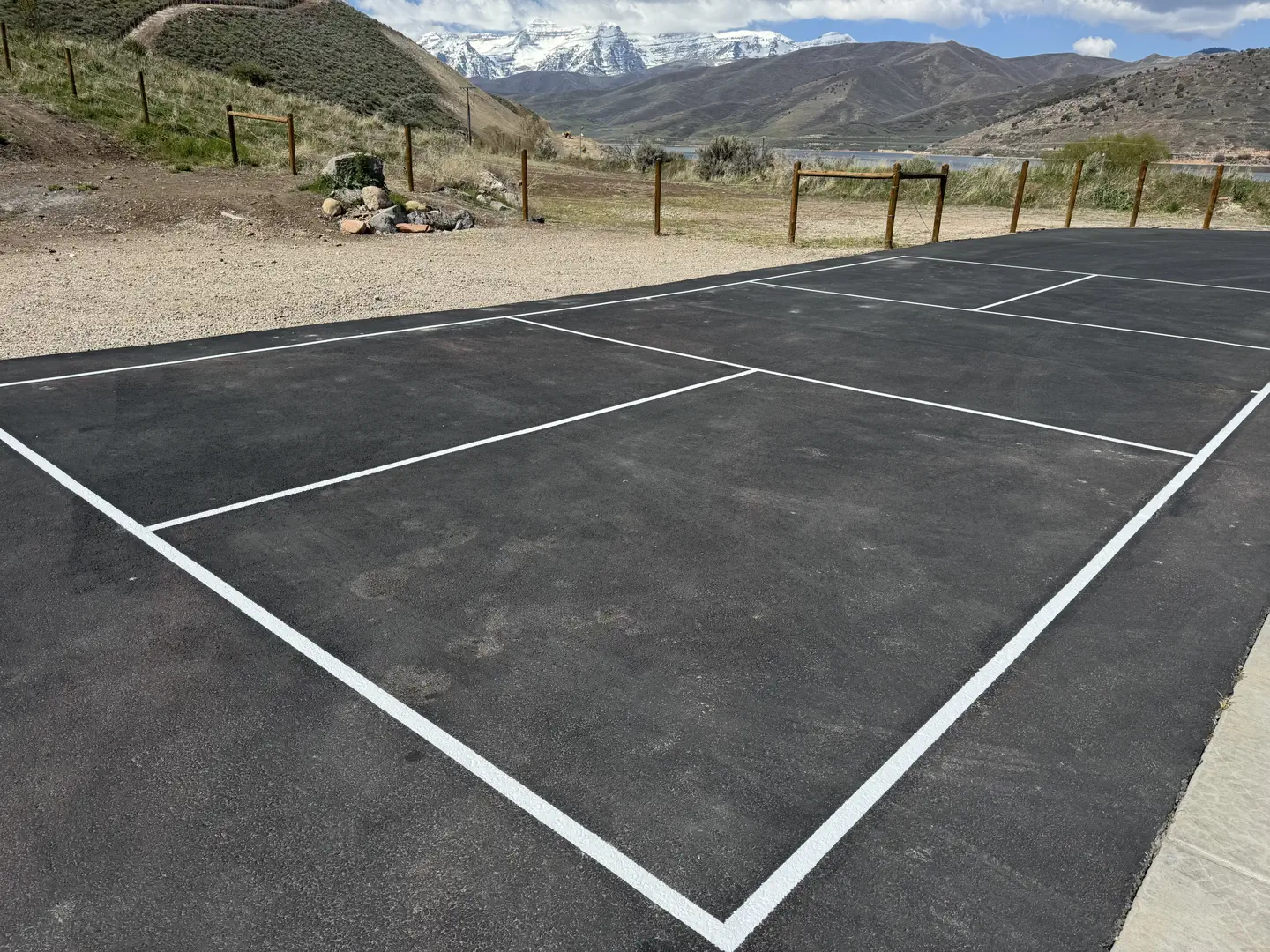 Newly lined pickleball court with mountain and lake view