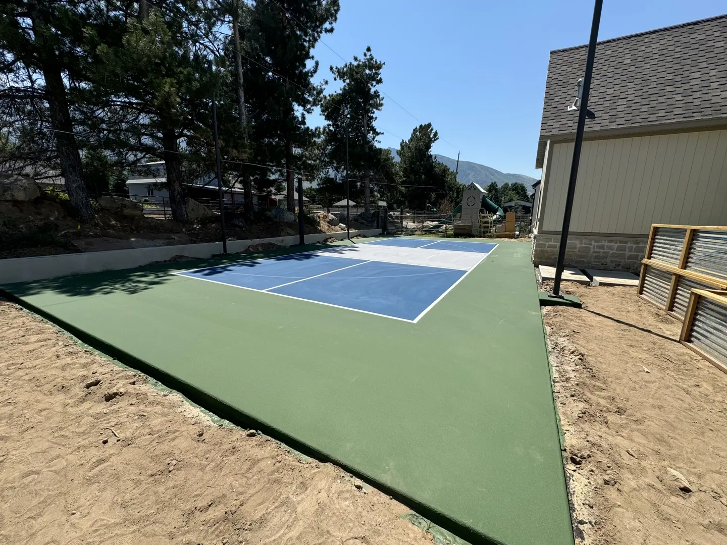 Newly constructed pickleball court with blue and white playing surface.