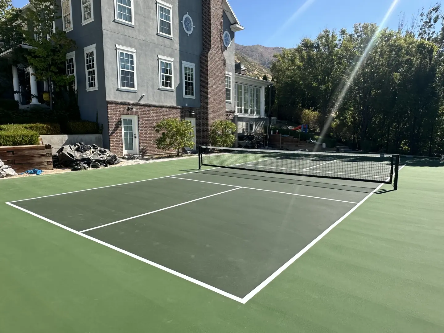 Newly painted pickleball court with white lines and a net.