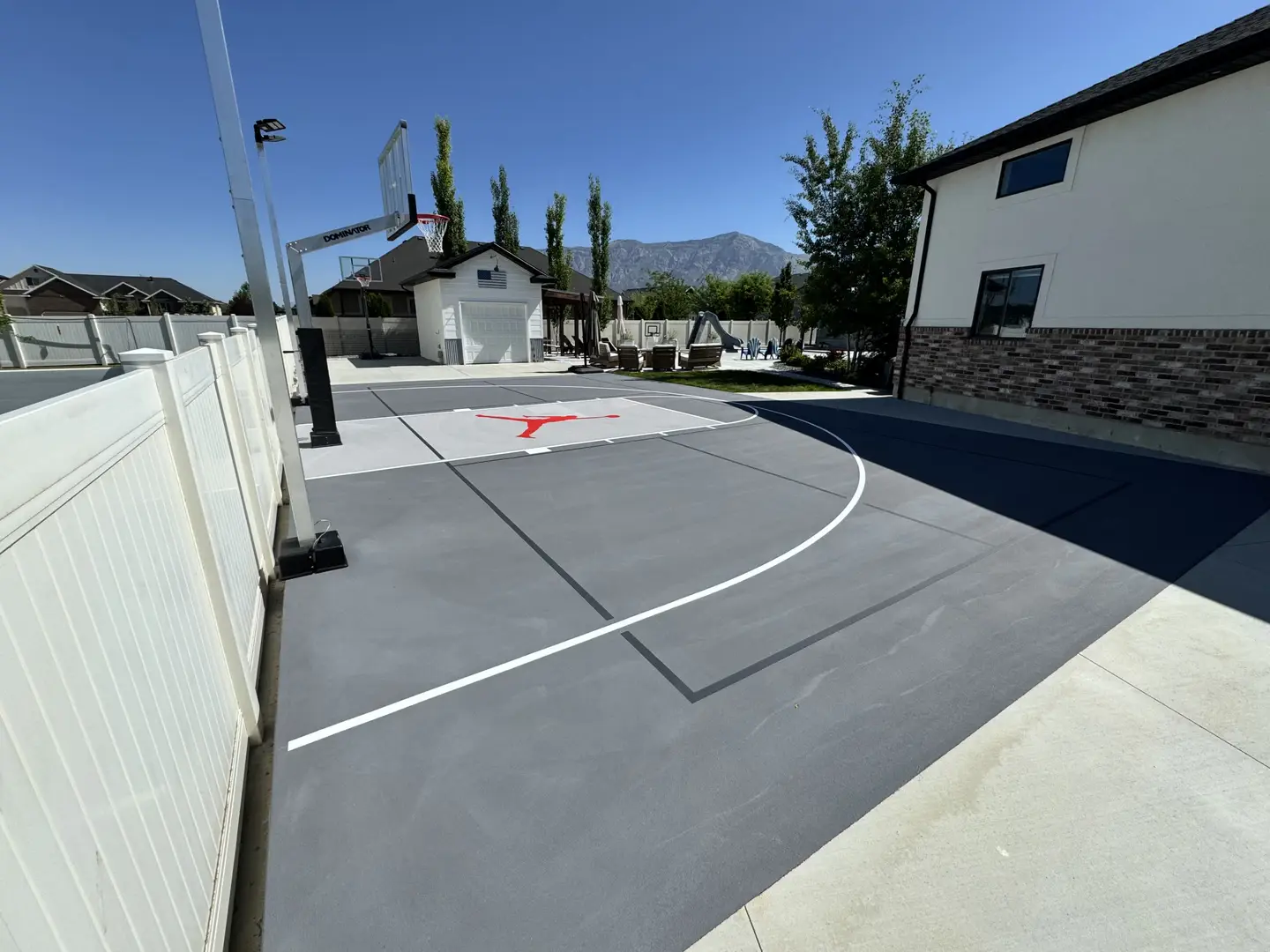 Custom backyard basketball court with Jordan logo in Utah