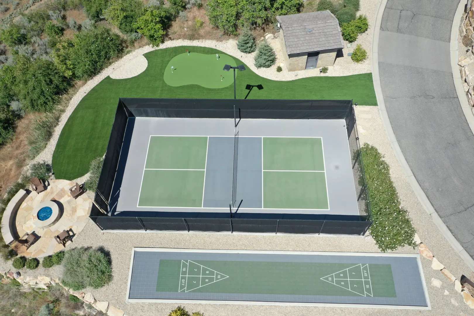 Aerial view of a pickleball court, putting green, and shuffleboard court.