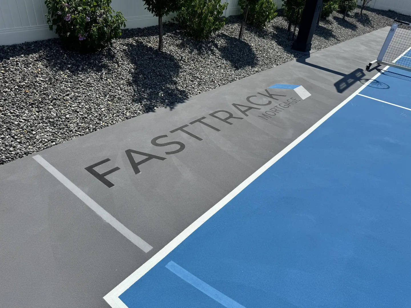 FastTrack Mortgage logo on a blue and grey court.