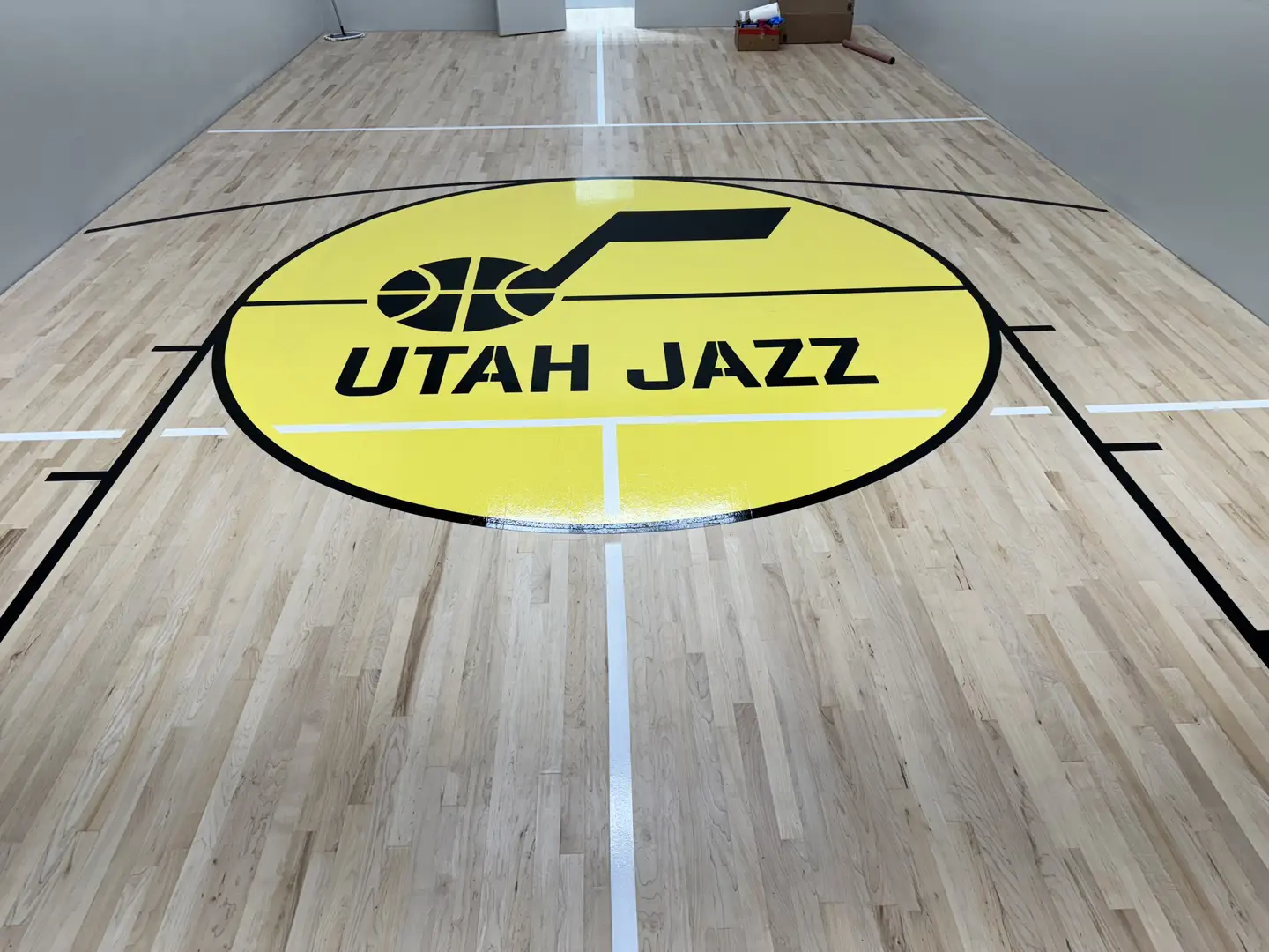 Utah Jazz logo on a polished basketball court