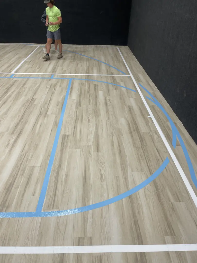 New pickleball court lines on a wooden floor