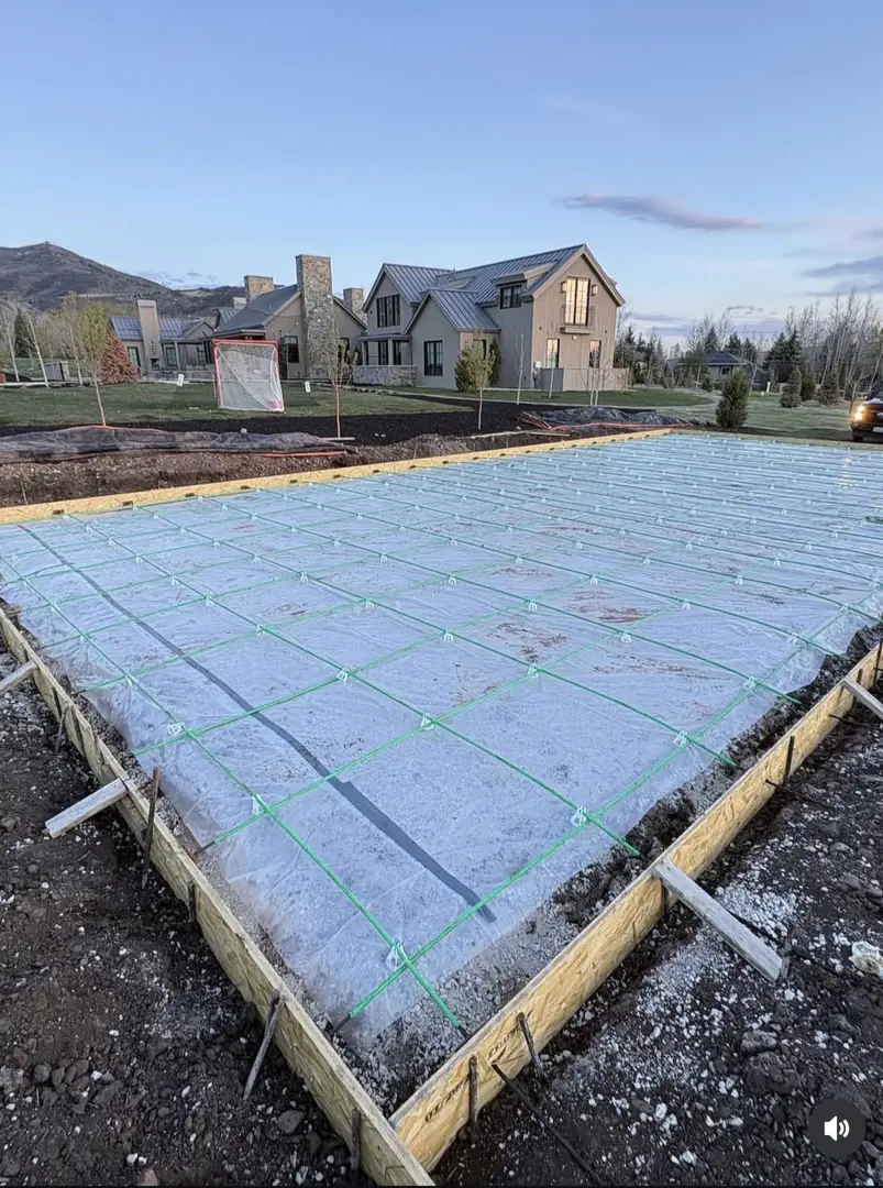 Concrete slab preparation with vapor barrier and rebar grid