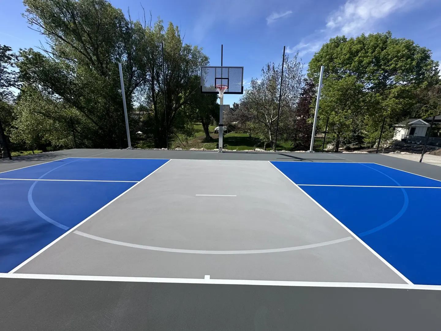 Outdoor basketball court with blue and grey sections