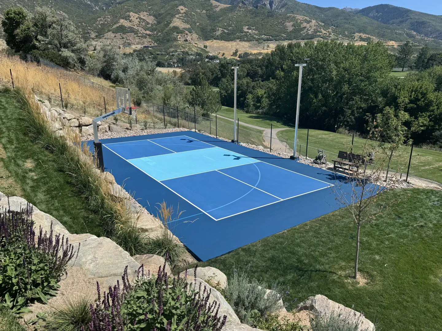 Scenic blue basketball court with mountain backdrop