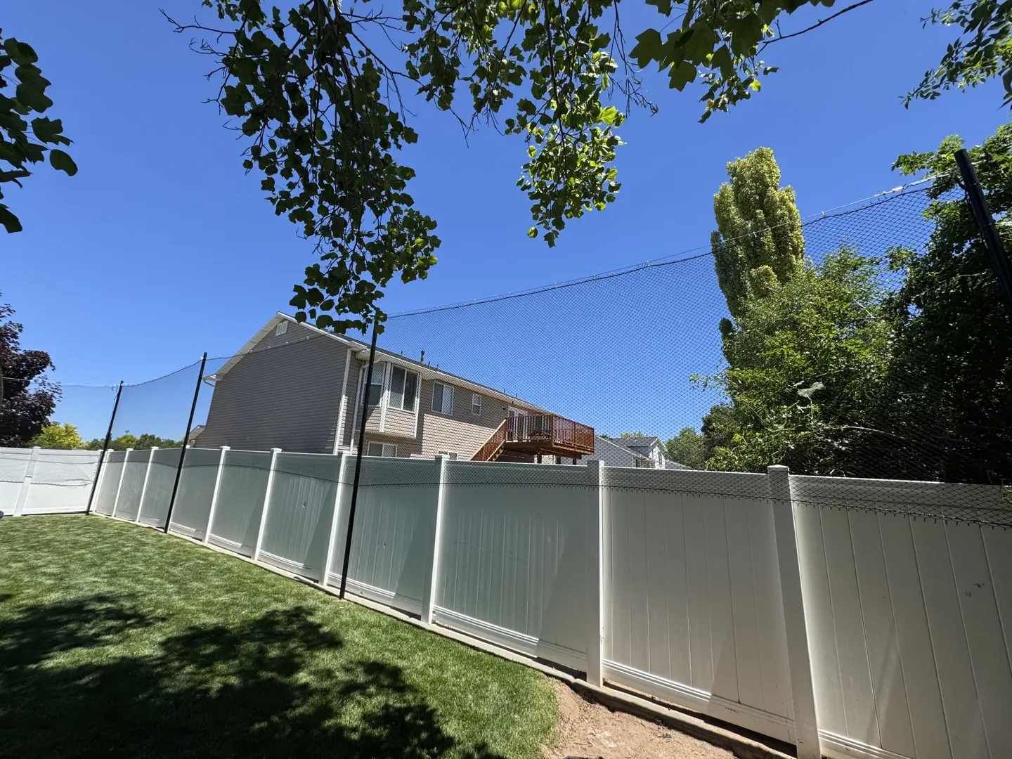 Backyard fence with netting for sports protection