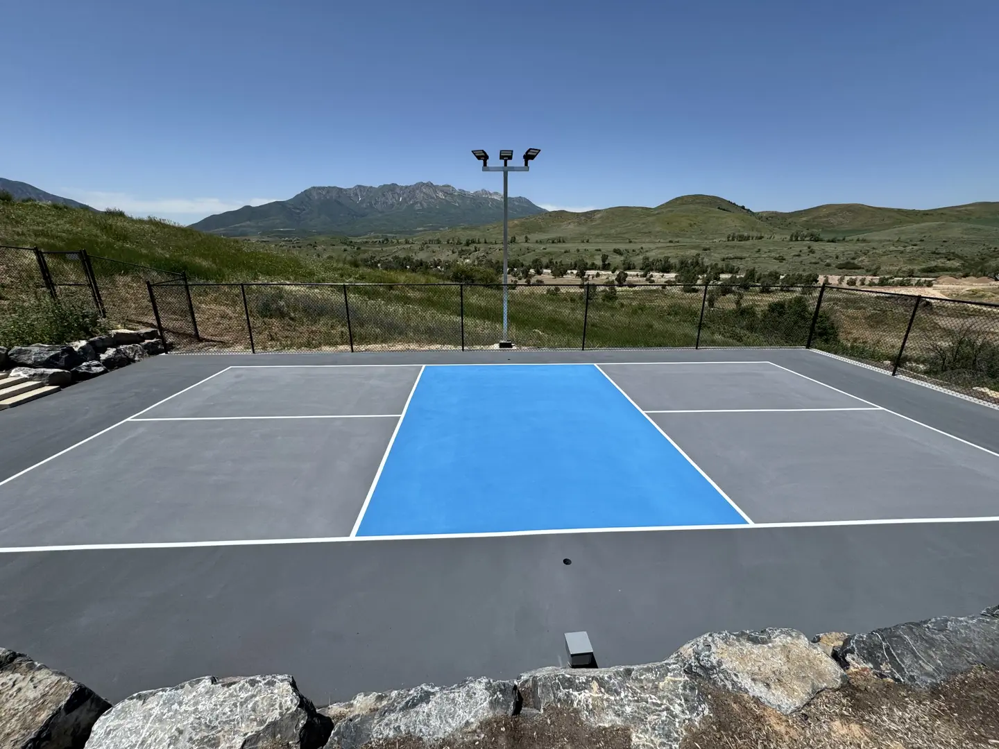 Outdoor pickleball court with mountain views