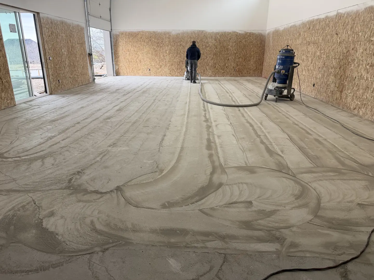 Concrete floor preparation with grinder and dust extractor
