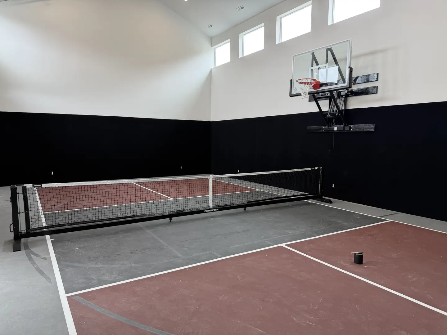 Indoor pickleball court with basketball hoop