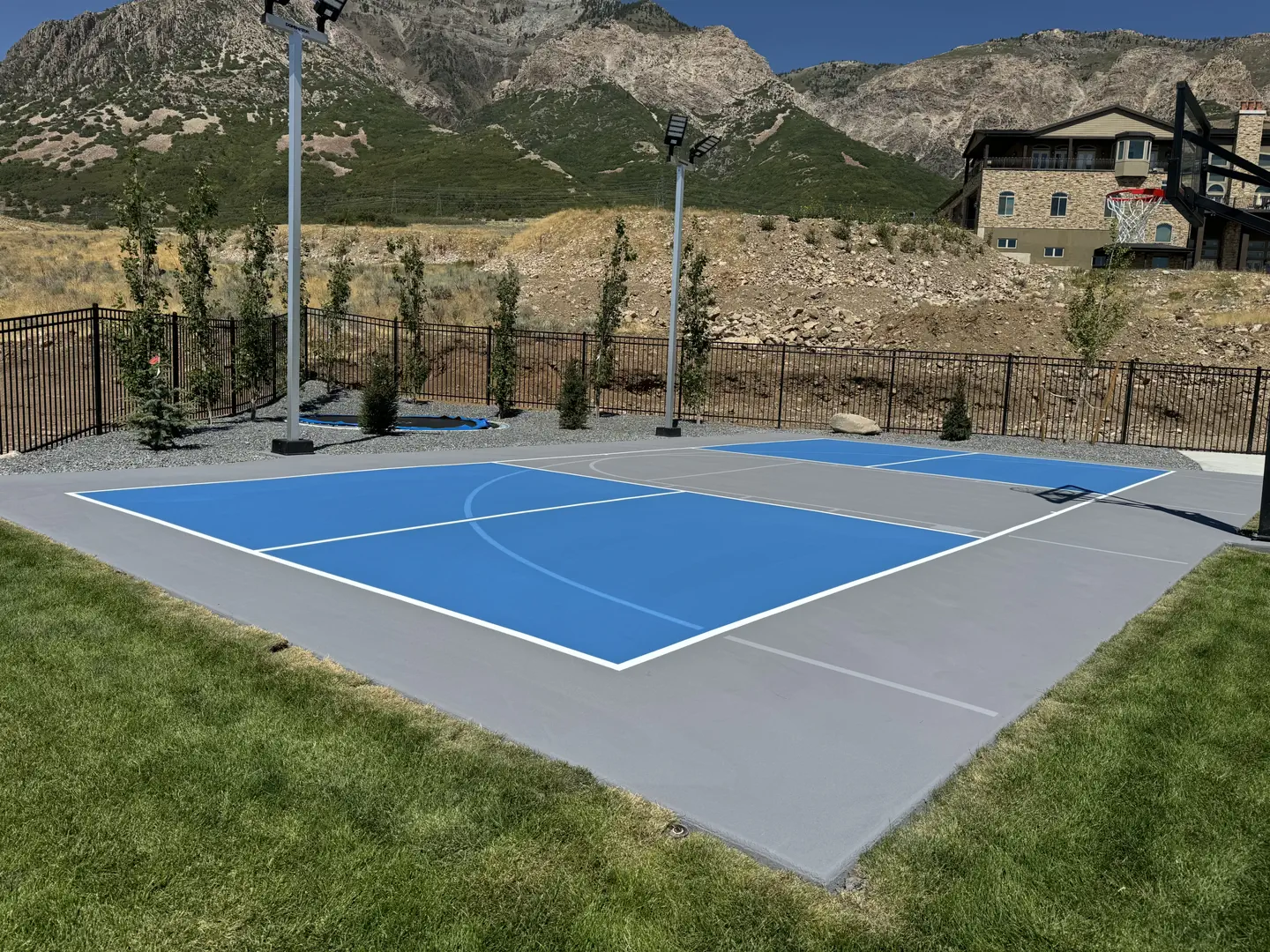 Blue and grey multi-sport court with mountain backdrop