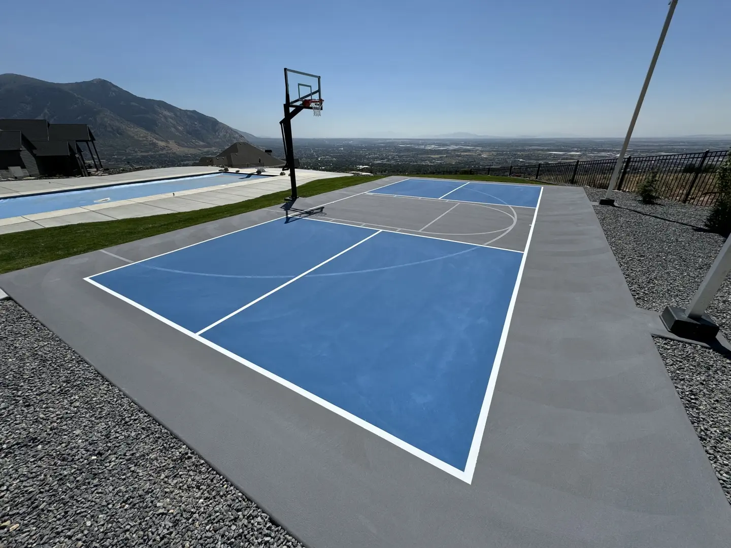 Blue and grey basketball court with a scenic view