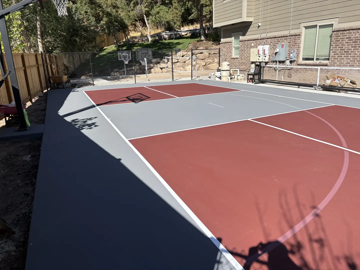 Newly painted multi-sport court with basketball hoop