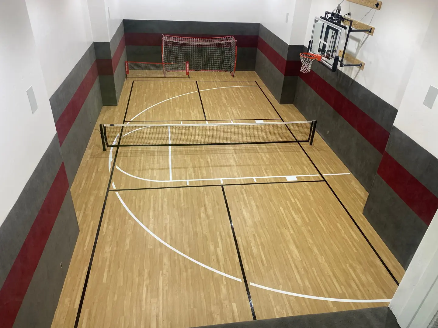 Indoor multi-sport court with basketball hoop and nets