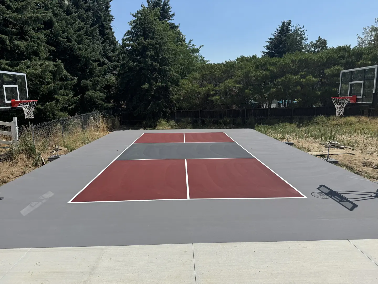 Newly painted multi-sport court with basketball hoops