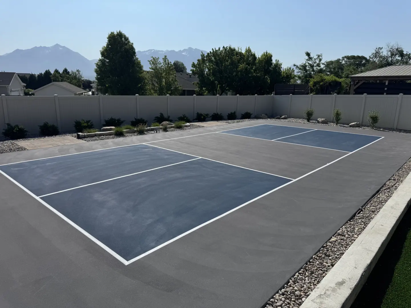 New outdoor pickleball court with blue and gray surfacing.