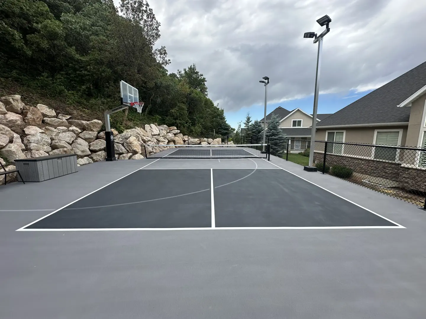 Multi-sport court with basketball hoop and pickleball lines