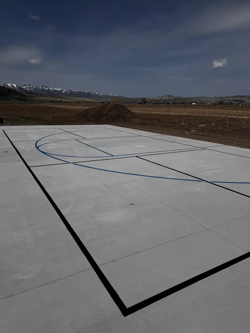 Newly painted basketball court in a rural landscape