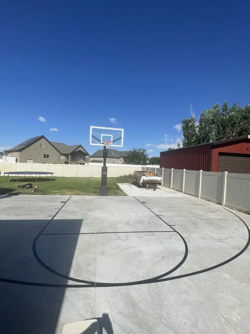 Outdoor basketball court with a clear blue sky.