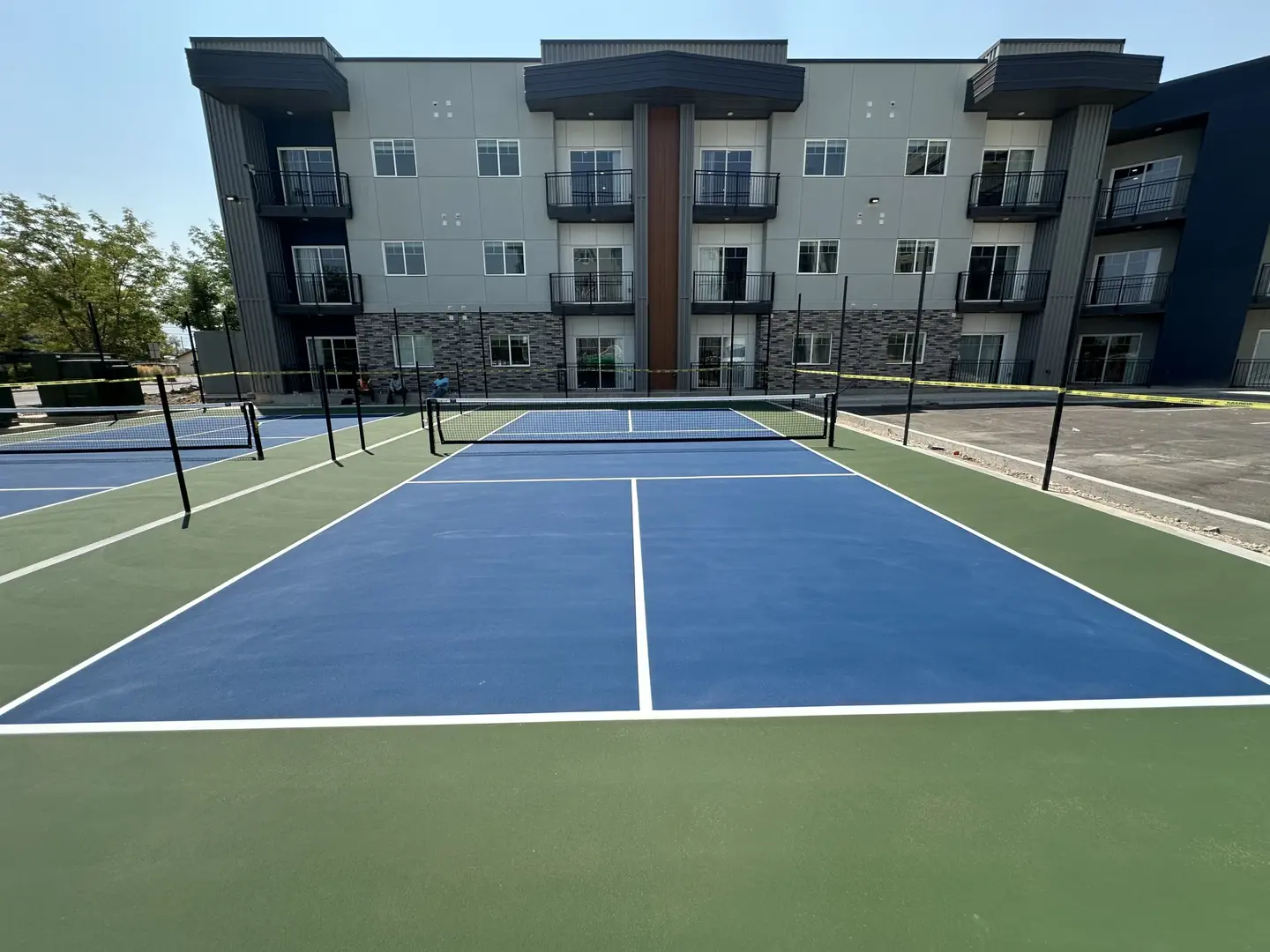 New pickleball courts next to an apartment building