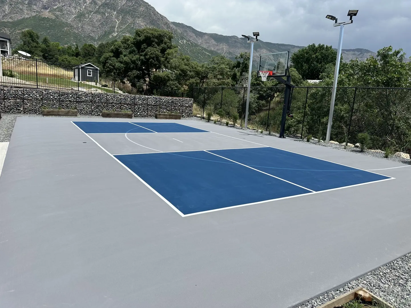 Blue and gray basketball court with mountain backdrop